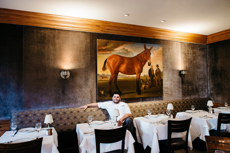 The chef of Peninsula Grill in Charleston poses in front of the restaurant