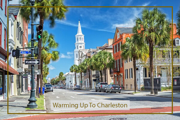 a street with palm trees and a church in the background