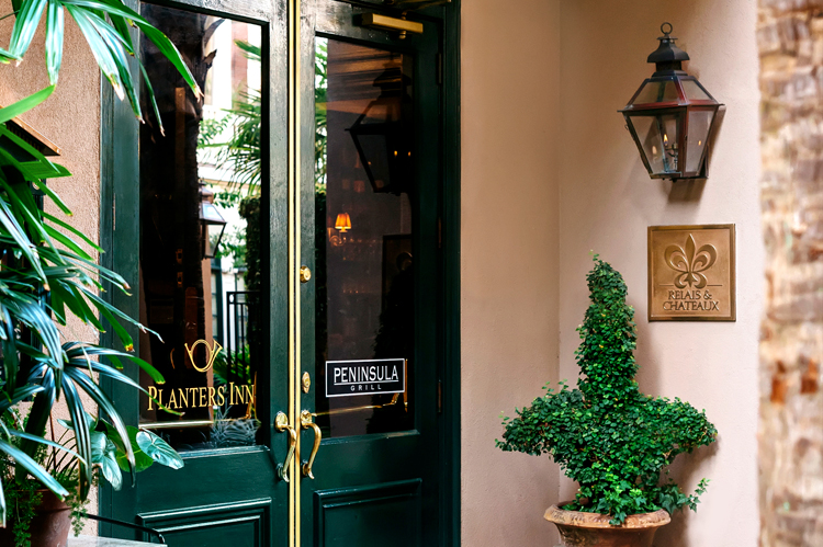 The garden entrance to Planters Inn, a luxury hotel in Charleston SC