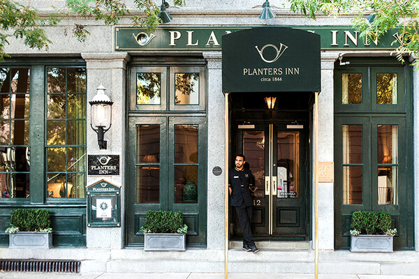 a man standing in the doorway of a hotel